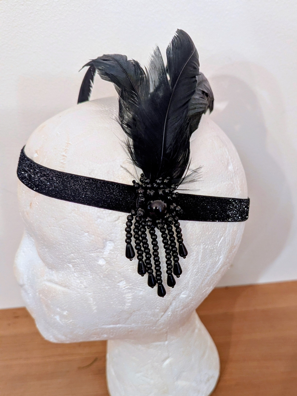 vintage-inspired 1920s flapper headband featuring soft black feathers